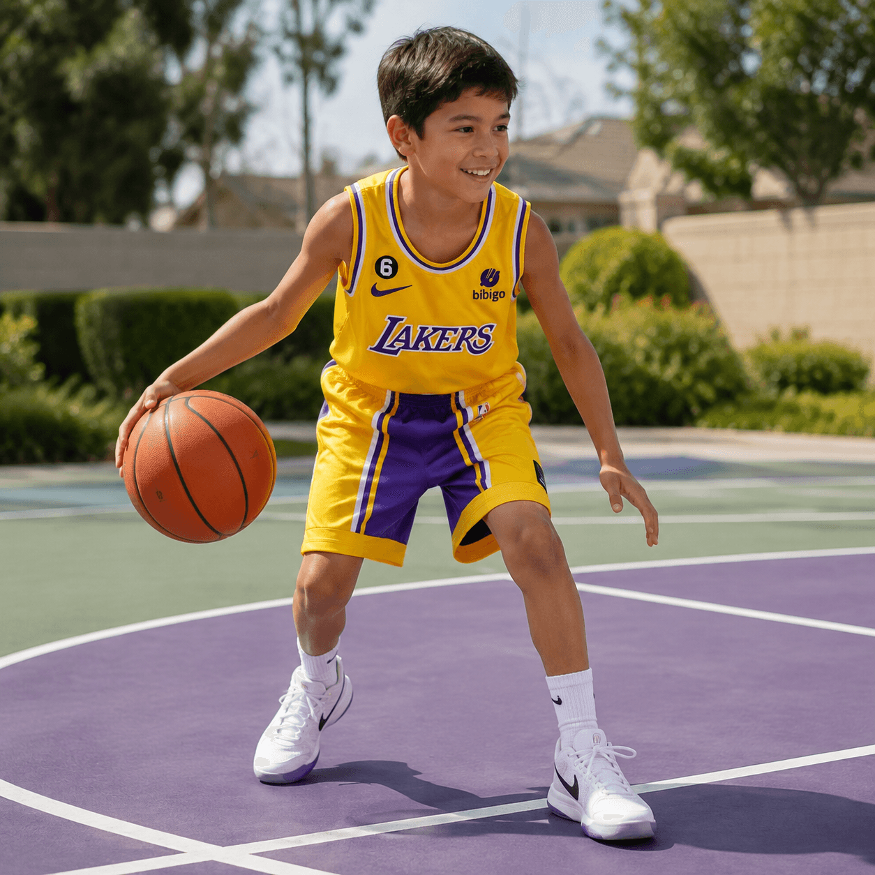 Niño usando uniforme de baloncesto Lakers amarillo talla 28 en cancha